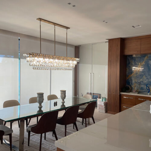 Enhance your kitchen with modern chandelier lighting for your counter area.