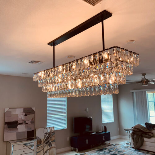 Enhance your kitchen with modern chandelier lighting for your counter area.