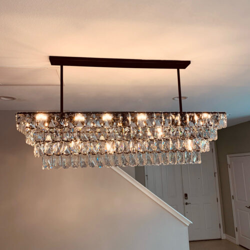 Enhance your kitchen with modern chandelier lighting for your counter area.